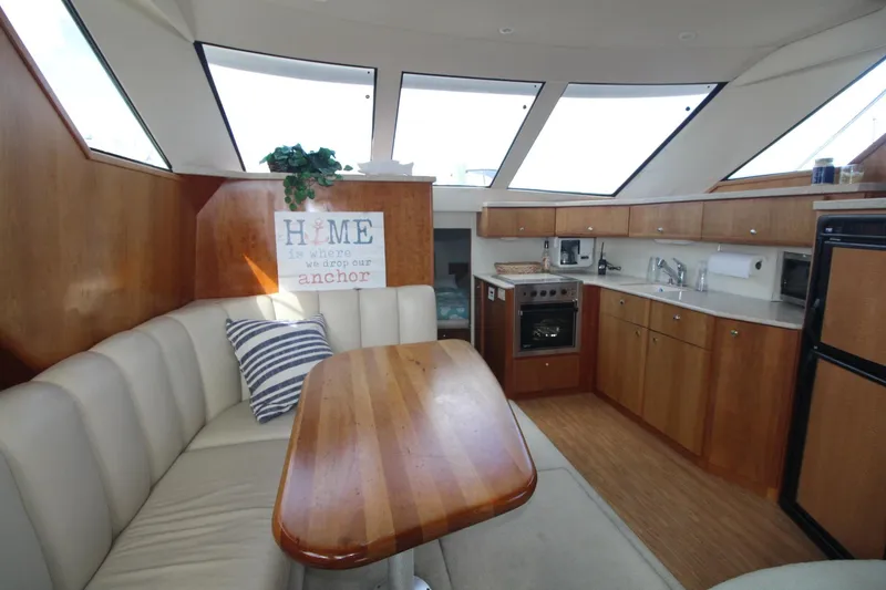 Slide: The Image of Interior of 2000 Silverton 392 Motor Yacht with dining area and kitchen. - 40