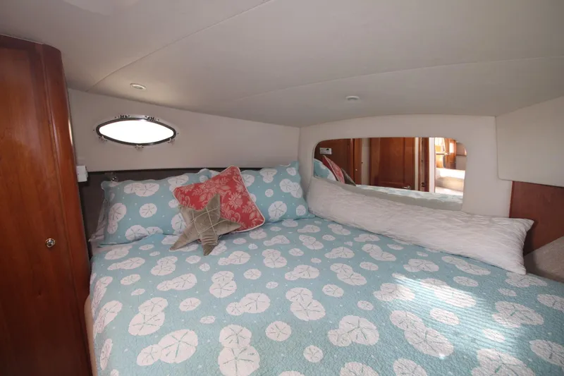 Slide: The Image of Cozy bedroom in 2000 Silverton 392 Motor Yacht with nautical-themed bedding and porthole window. - 45