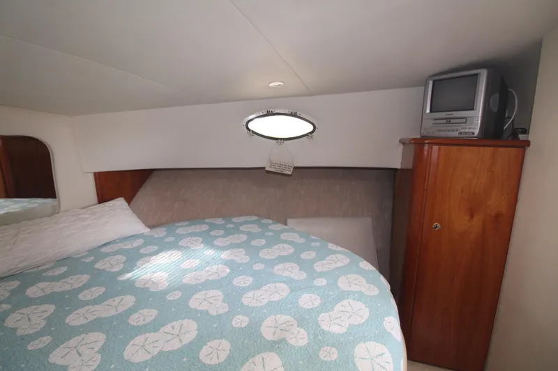 Slide: The Image of Cozy bedroom in 2000 Silverton 392 Motor Yacht with TV and patterned bedding. - 47