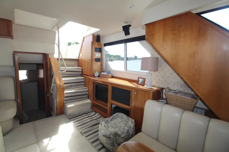 Slide: The Image of Interior of 2000 Silverton 392 Motor Yacht with cozy seating and elegant wood finishes. - 49