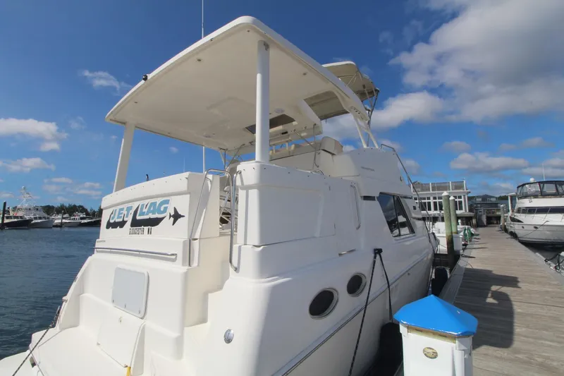 Slide: The Image of 2000 Silverton 392 Motor Yacht docked at marina under clear blue sky. - 5