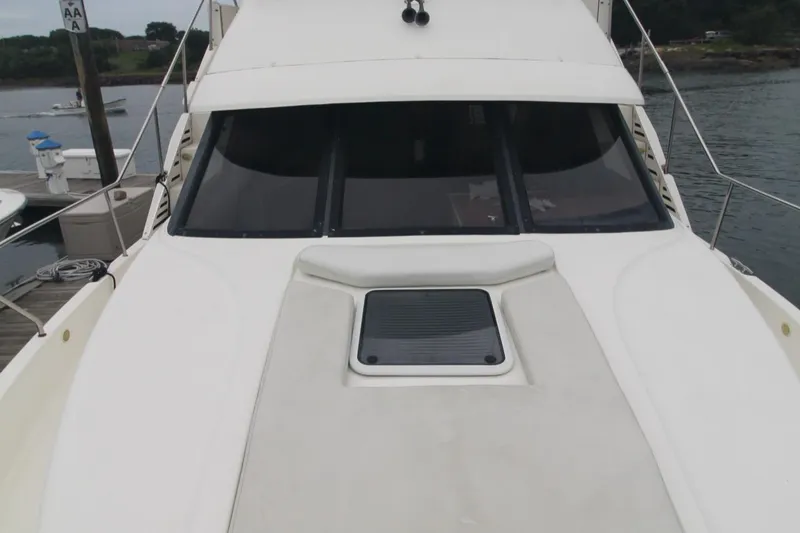 Slide: The Image of 2000 Silverton 392 Motor Yacht, front deck view, docked by the water. - 8