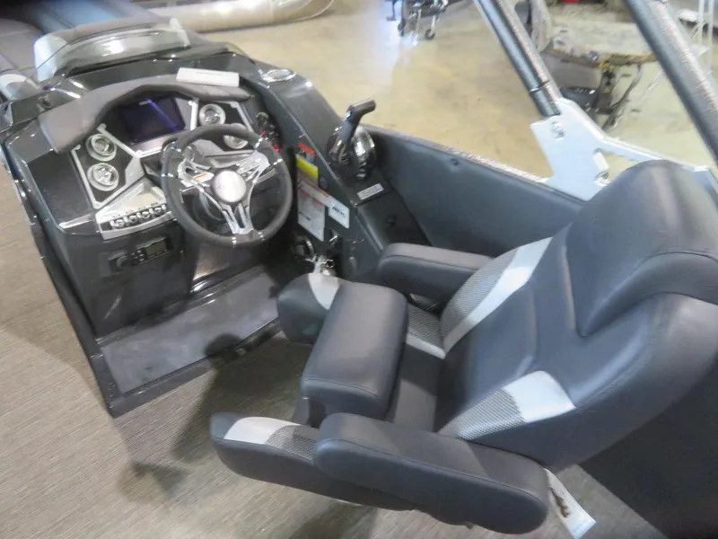 Slide: The Image of 2023 Crest Caribbean RS 250 SLS CP3 boat cockpit with steering wheel and captain's chair. - 11