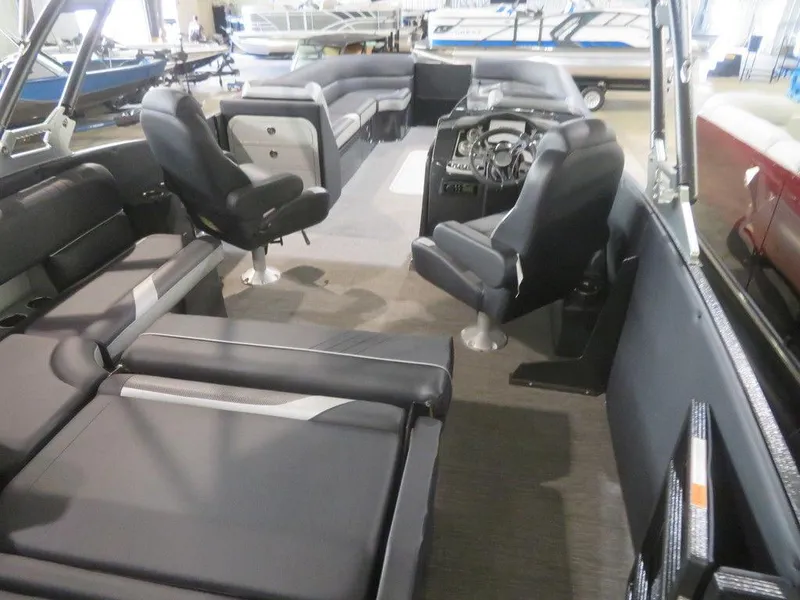 Slide: The Image of 2023 Crest Caribbean RS 250 SLS CP3 interior with black seating and modern dashboard. - 23