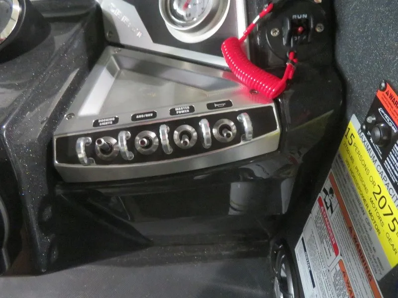 Slide: The Image of Control panel of 2023 Crest Caribbean RS 250 SLS CP3 boat with switches and safety lanyard. - 24