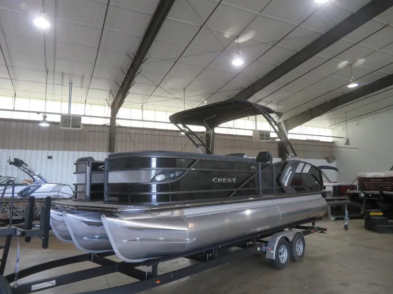 Slide: The Image of 2023 Crest Caribbean RS 250 SLS CP3 pontoon boat in indoor storage. - 25