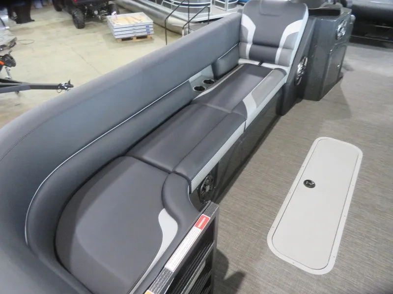 Slide: The Image of 2023 Crest Caribbean RS 250 SLS CP3 boat interior with gray seating and storage compartment. - 3