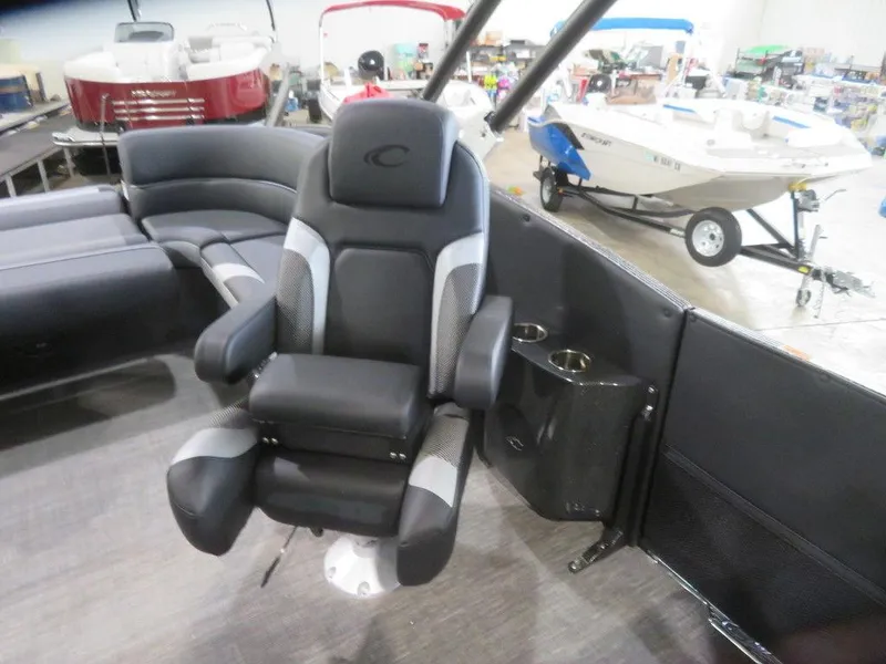 Slide: The Image of 2023 Crest Caribbean RS 250 SLS CP3 boat interior with captain's chair and seating area. - 8