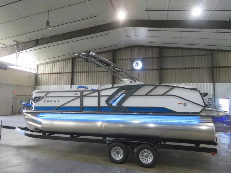 Slide: The Image of 2023 Crest Caribbean RS 230 SLC CP3 pontoon boat in a warehouse. - 2