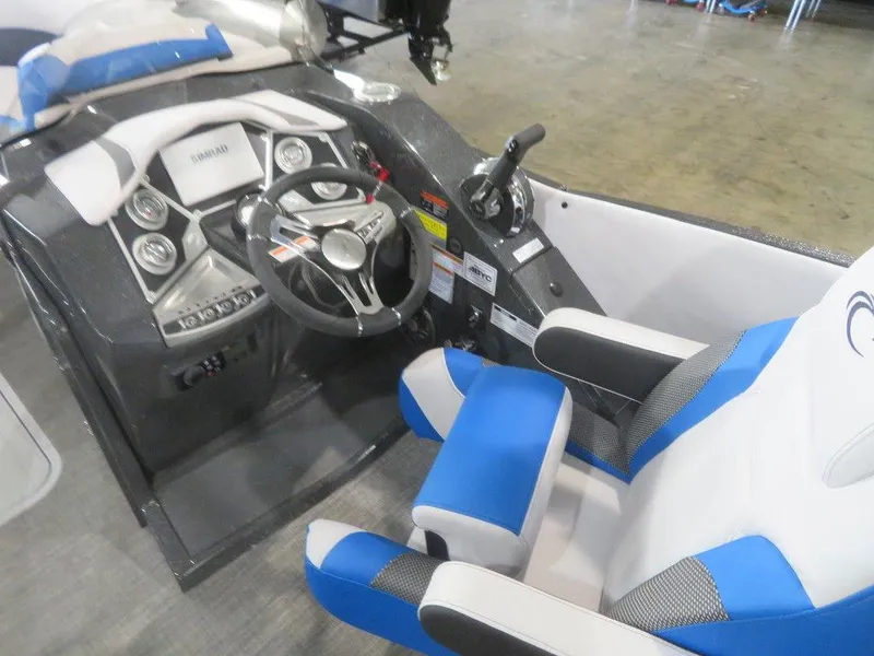 Slide: The Image of 2023 Crest Caribbean RS 230 SLC CP3 boat cockpit with steering wheel and blue seats. - 22