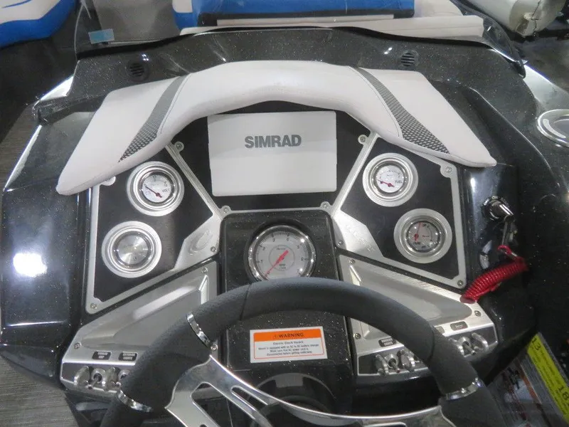 Slide: The Image of 2023 Crest Caribbean RS 230 SLC CP3 boat dashboard with Simrad display and gauges. - 24