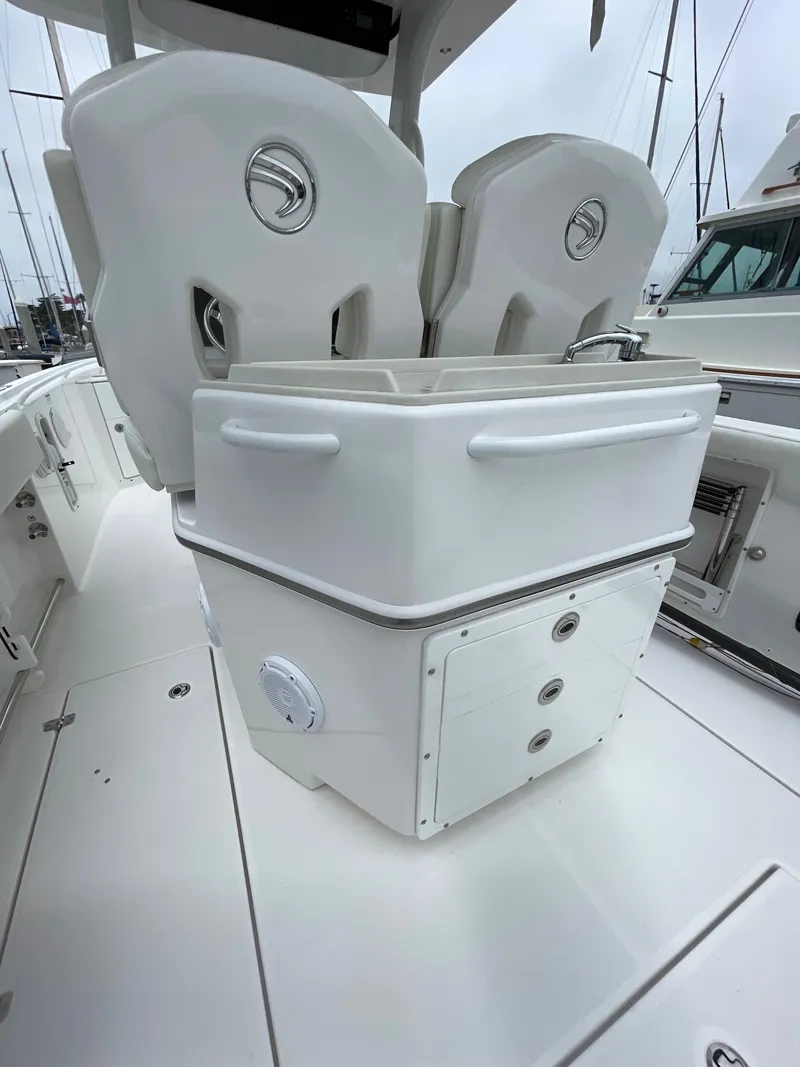 Slide: The Image of 2021 Edgewater 262CC boat dashboard showing Yamaha display with trip and total hours. - 14