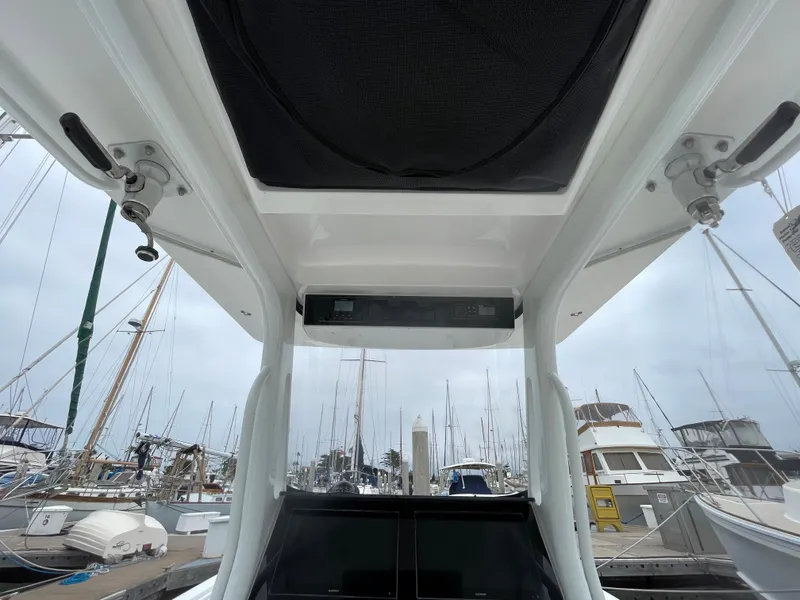 Slide: The Image of 2021 Edgewater 262CC boat anchor storage compartment with rope and cleat. - 15