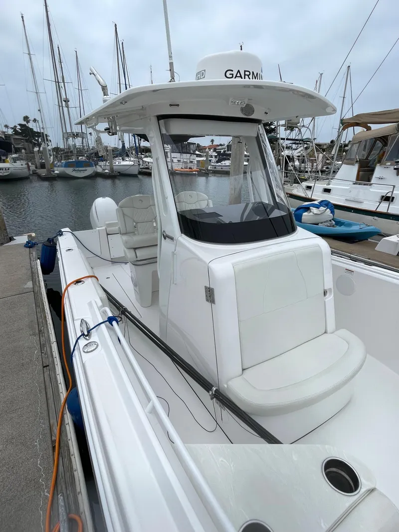 Slide: The Image of 2021 Edgewater 262CC boat named "Barefoot Dreams" on a trailer, sunny day. - 3