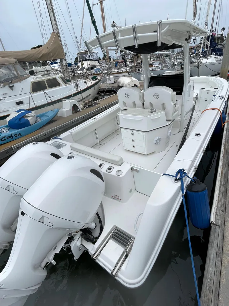 Slide: The Image of 2021 Edgewater 262CC boat docked at marina with Garmin equipment. - 6