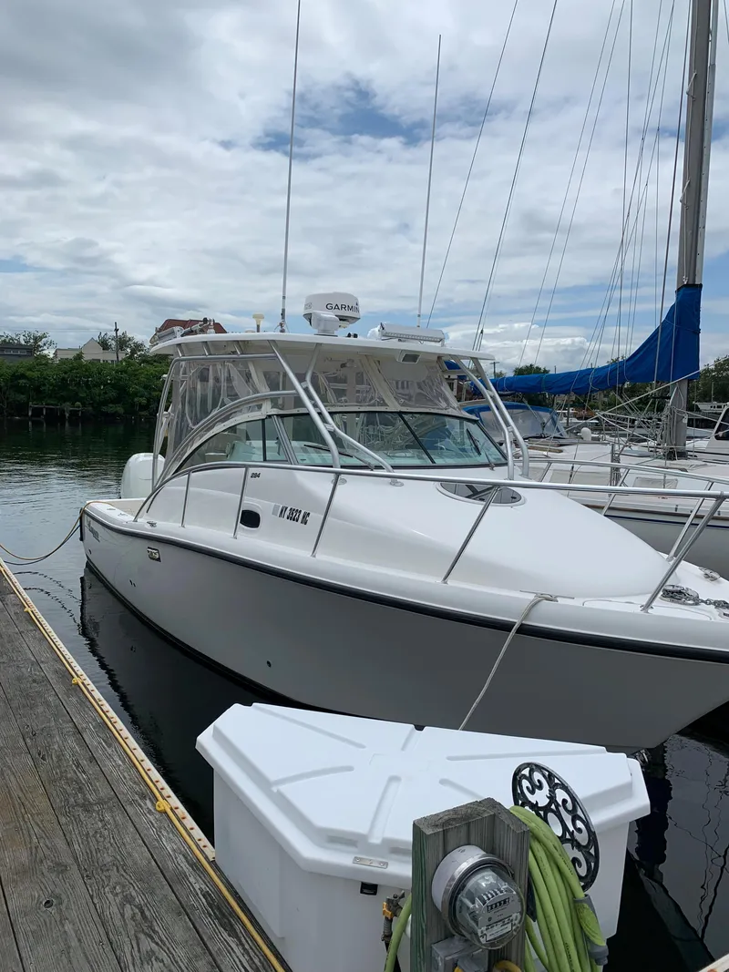 Slide: The Image of 2009 Mako 284 Express boat docked at a marina. - 1