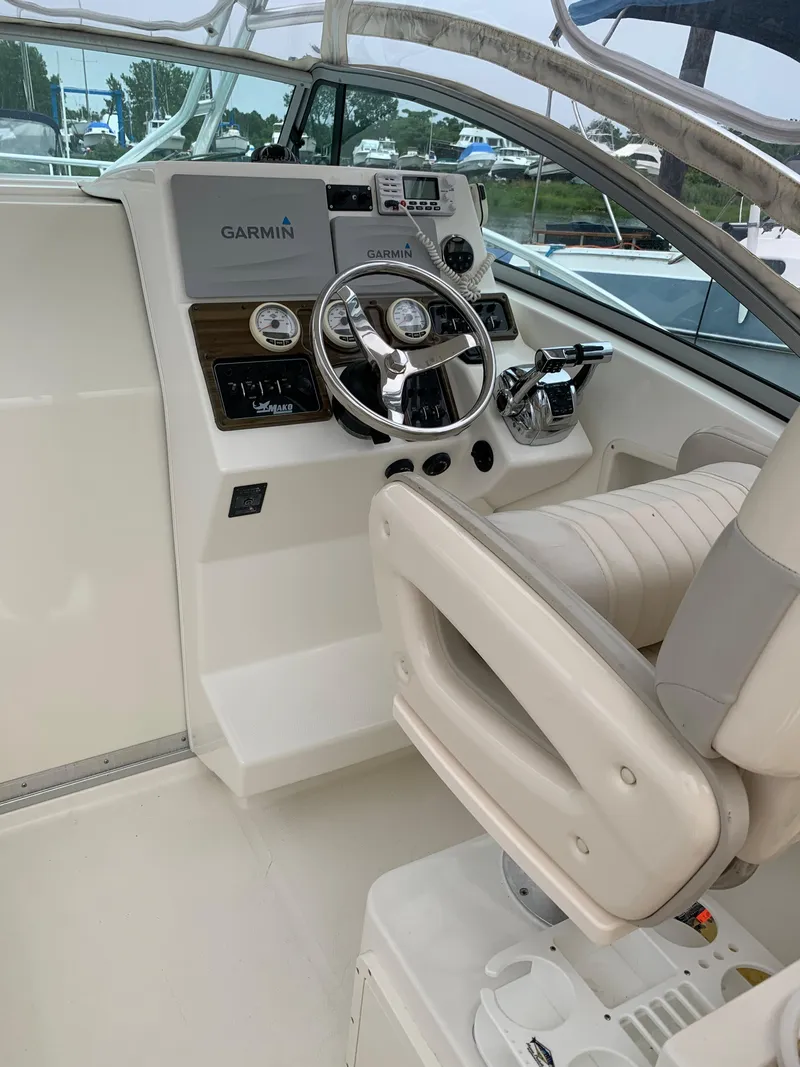 Slide: The Image of 2009 Mako 284 Express boat cockpit with Garmin navigation system. - 10