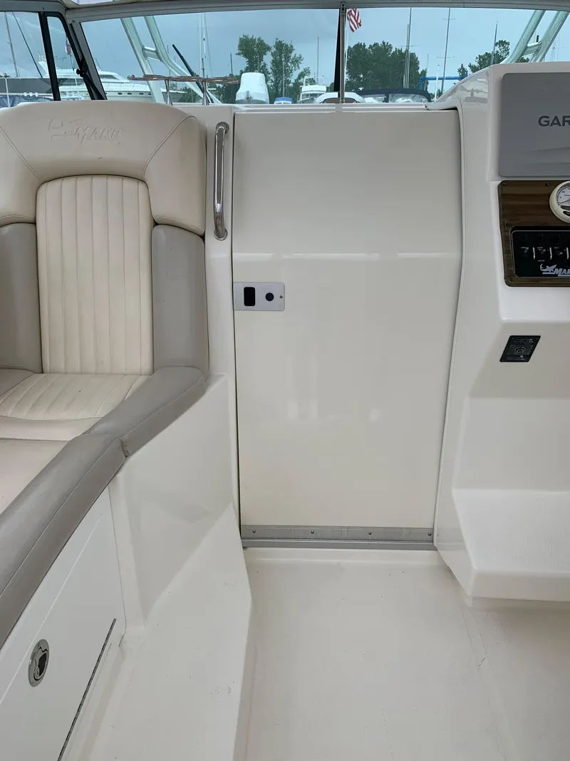 Slide: The Image of Interior of a 2009 Mako 284 Express boat with seating and control panel. - 13