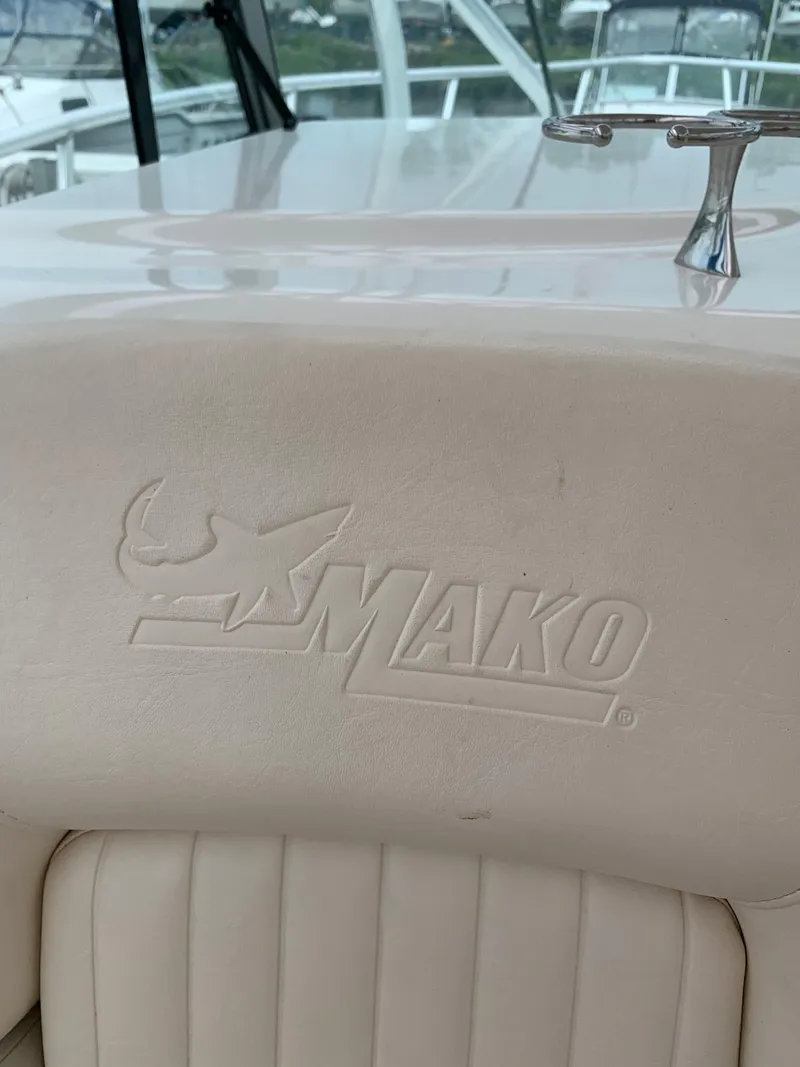 Slide: The Image of 2009 Mako 284 Express boat interior with embossed logo. - 16