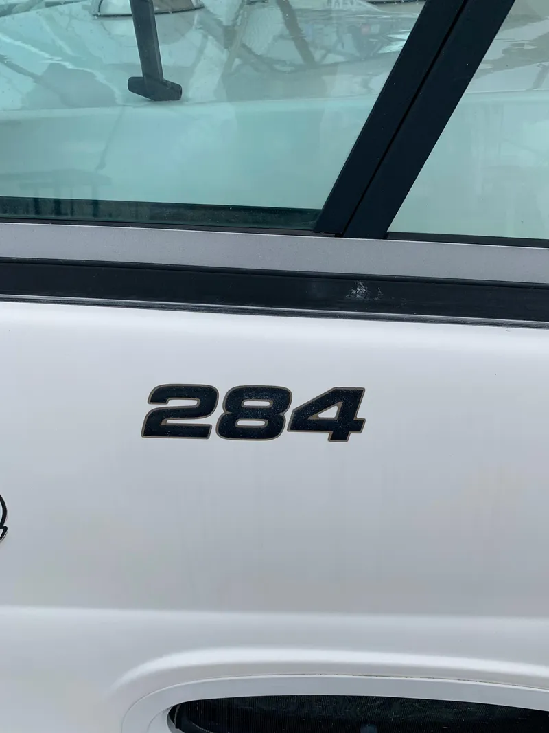 Slide: The Image of 2009 Mako 284 Express boat model number on white exterior. - 17
