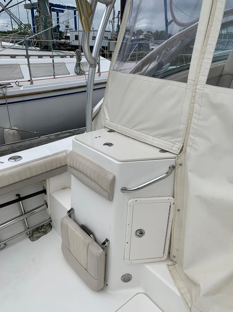 Slide: The Image of 2009 Mako 284 Express boat interior with seating and storage compartments. - 19