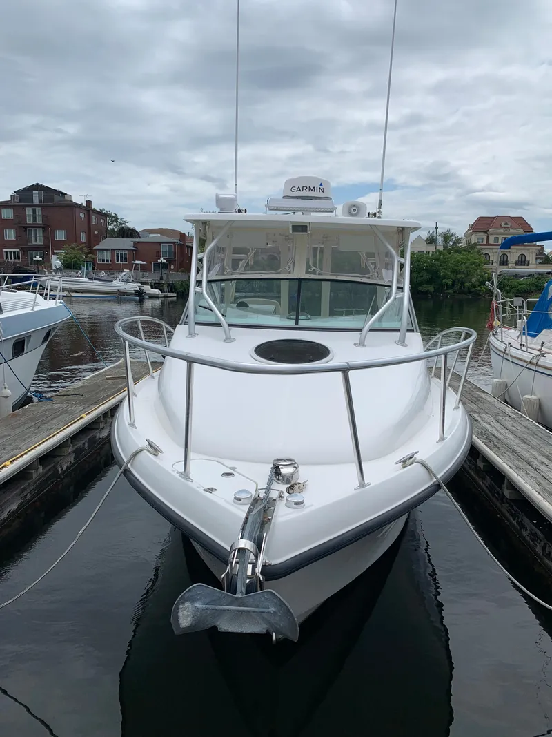 Slide: The Image of 2009 Mako 284 Express boat docked in a marina. - 2