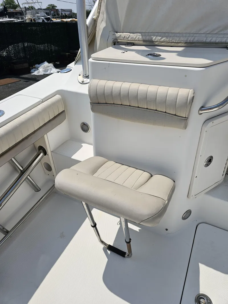 Slide: The Image of 2009 Mako 284 Express boat interior with cushioned seating and stainless steel fixtures. - 25