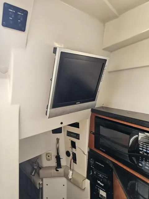 Slide: The Image of Interior of 2009 Mako 284 Express boat with TV and microwave. - 30