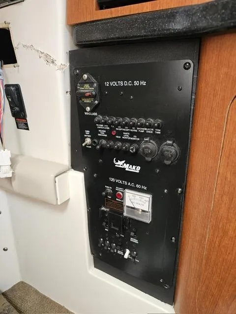 Slide: The Image of Electrical control panel on a 2009 Mako 284 Express boat. - 35