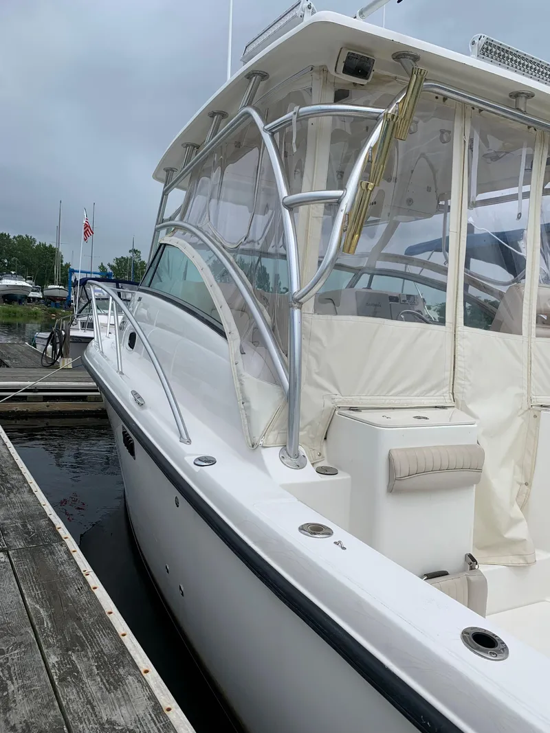 Slide: The Image of 2009 Mako 284 Express boat docked at a marina. - 4