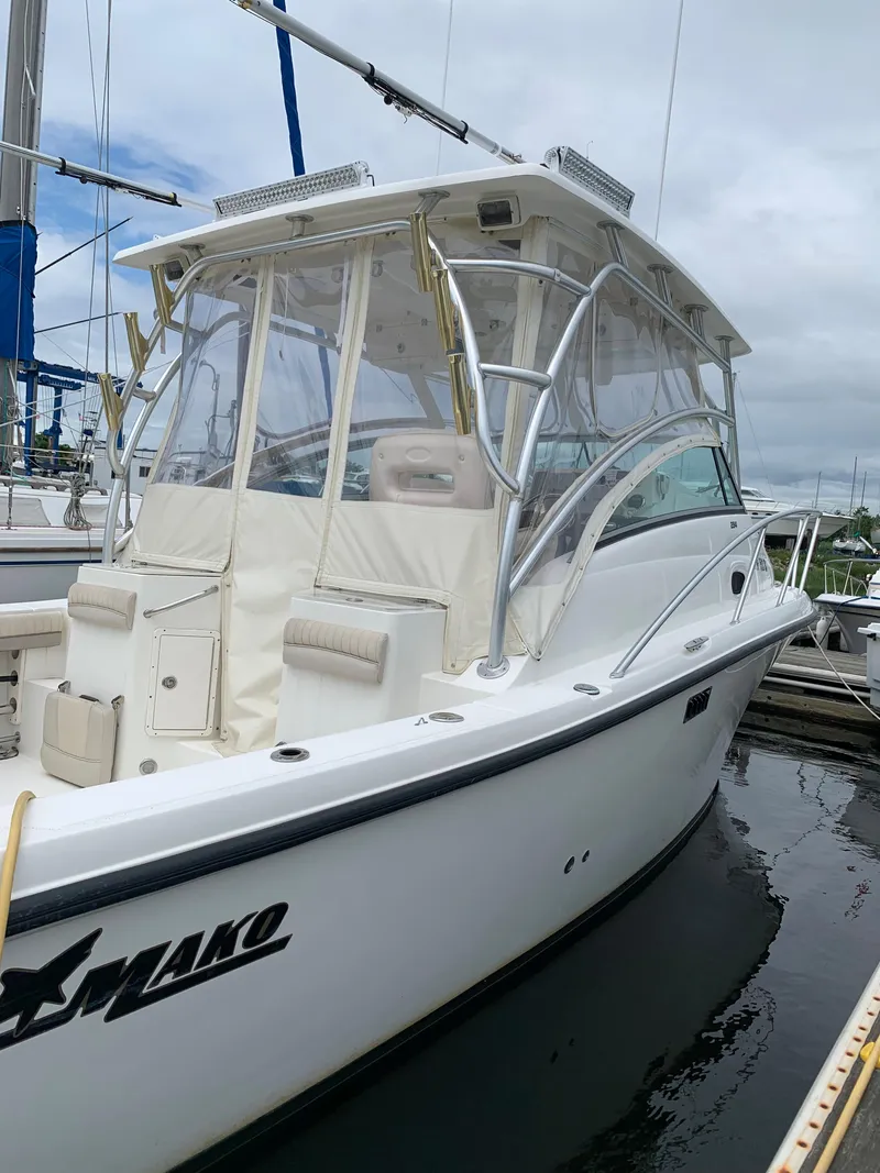 Slide: The Image of 2009 Mako 284 Express boat docked at a marina. - 5