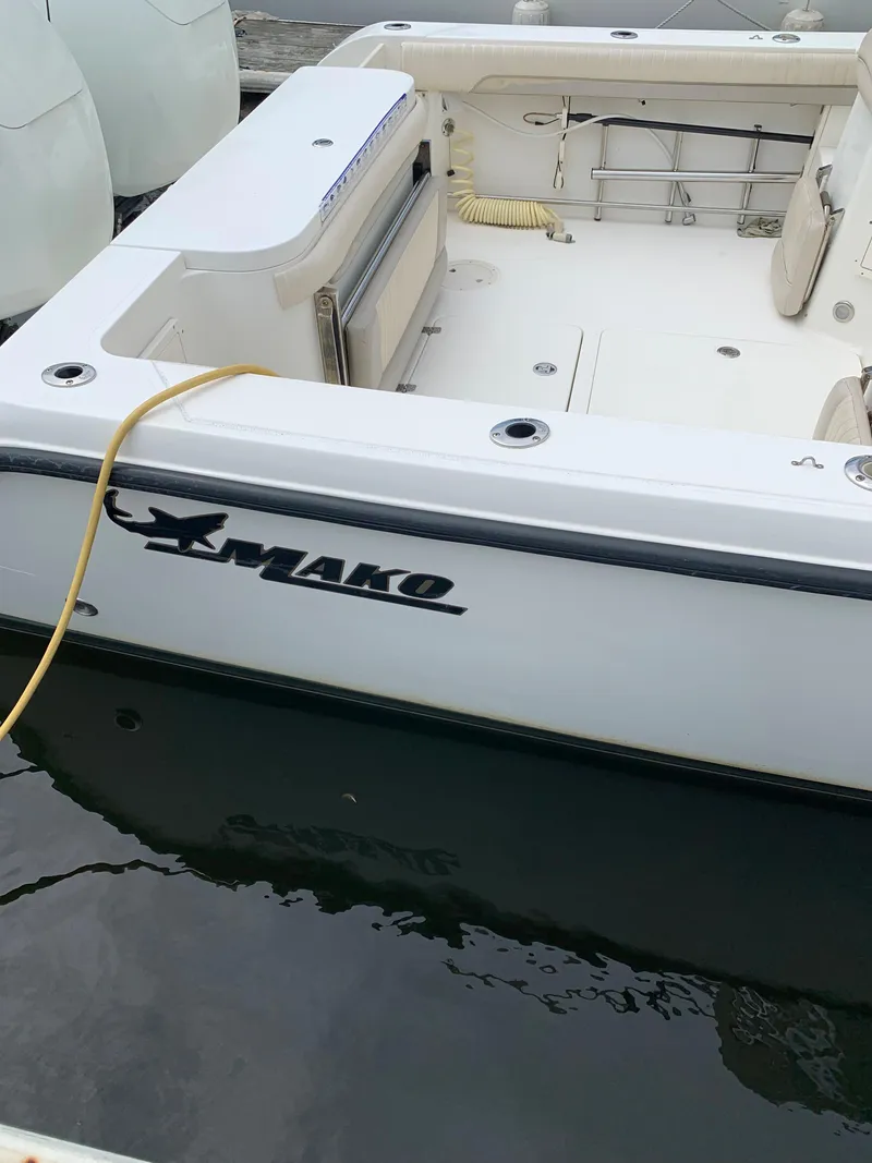 Slide: The Image of 2009 Mako 284 Express boat docked, rear view. - 7