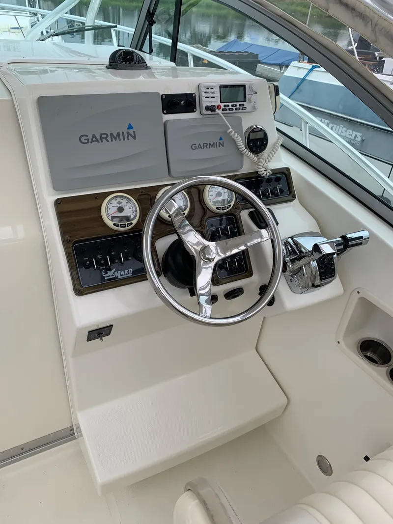 Slide: The Image of 2009 Mako 284 Express boat helm with Garmin navigation system. - 8