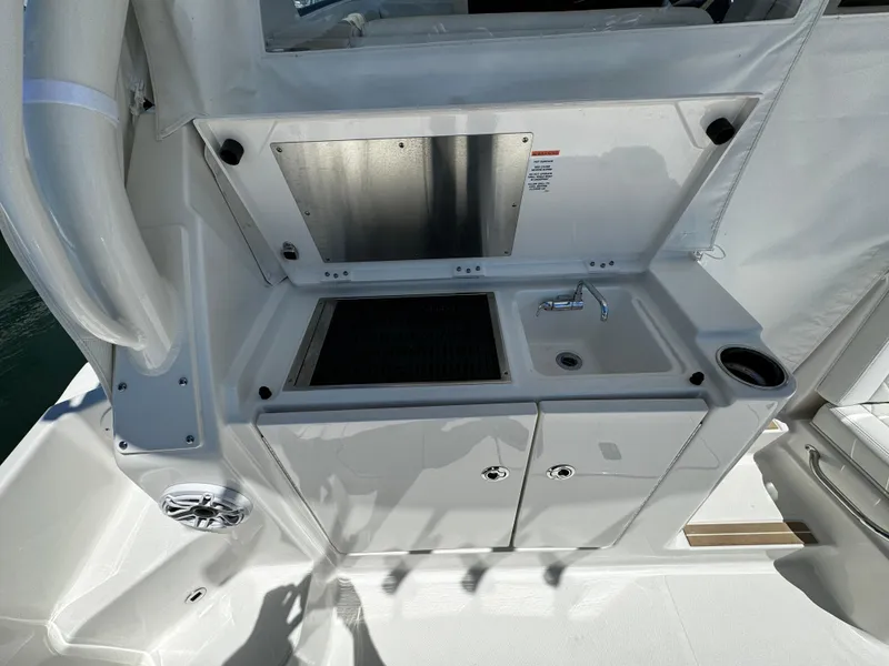 Slide: The Image of 2024 Pursuit OS 325 Offshore boat kitchenette with sink and storage. - 4
