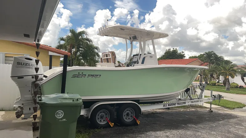 Slide: The Image of 2021 Sea Pro 259 DLX boat on trailer with Suzuki outboard motor. - 5