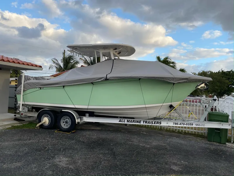Slide: The Image of 2021 Sea Pro 259 DLX boat on trailer with cover in residential driveway. - 6