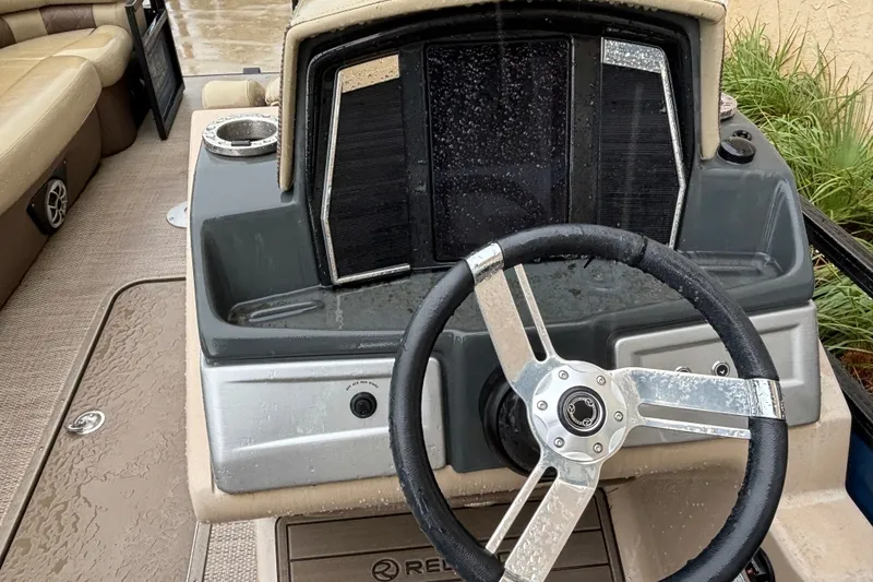 Slide: The Image of Steering console of 2023 Regency 230 LE3 boat with modern design and controls. - 9