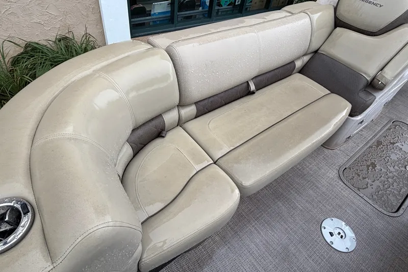 Slide: The Image of Beige seating on 2023 Regency 230 LE3 boat, featuring wet upholstery and cup holder. - 7