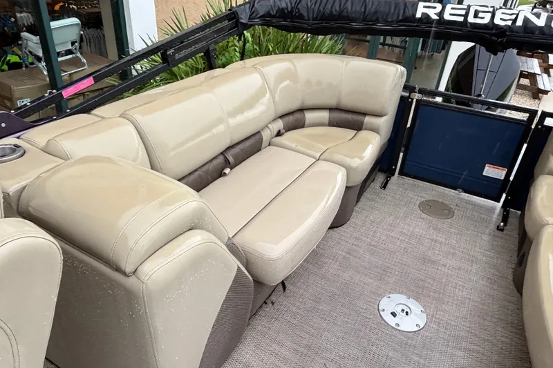 Slide: The Image of Luxurious seating on 2023 Regency 230 LE3 pontoon boat, featuring beige upholstery. - 3