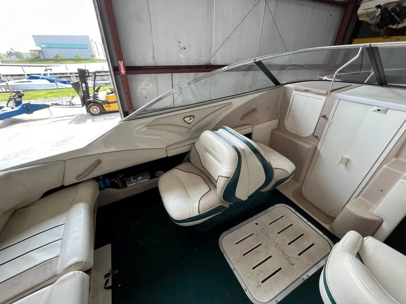 Slide: The Image of Interior of a 1997 Monterey 236 Montura boat with white and green seating. - 10