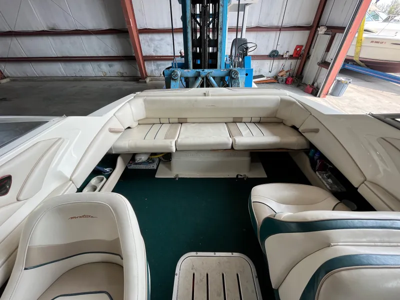 Slide: The Image of Interior of a 1997 Monterey 236 Montura boat with white seating and green carpet. - 12