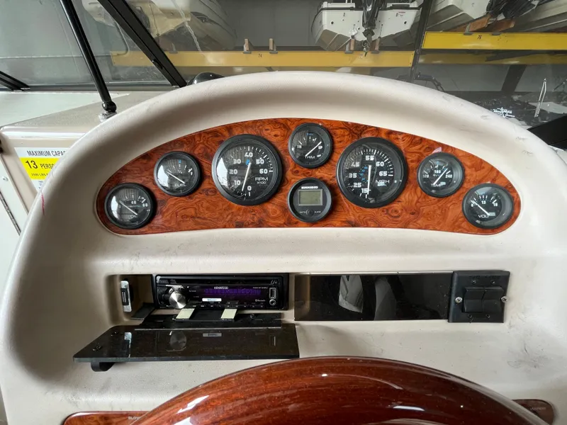 Slide: The Image of Dashboard of a 1997 Monterey 236 Montura boat with gauges and controls. - 13