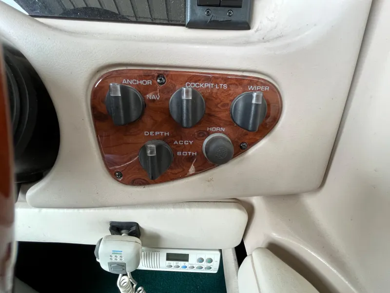 Slide: The Image of Control panel of a 1997 Monterey 236 Montura boat with various switches. - 14