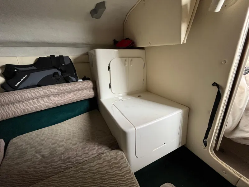 Slide: The Image of Interior cabin of a 1997 Monterey 236 Montura boat with seating and storage. - 16