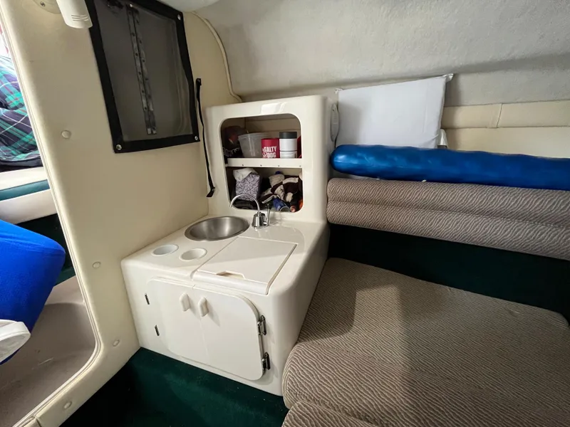 Slide: The Image of Compact kitchenette in a 1997 Monterey 236 Montura boat cabin. - 17