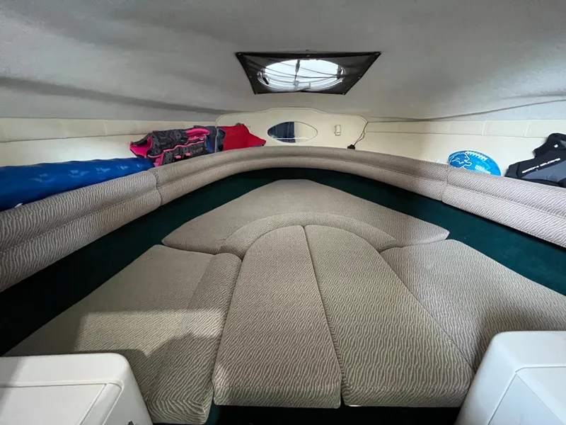 Slide: The Image of Interior cabin of a 1997 Monterey 236 Montura boat with cushioned seating. - 18