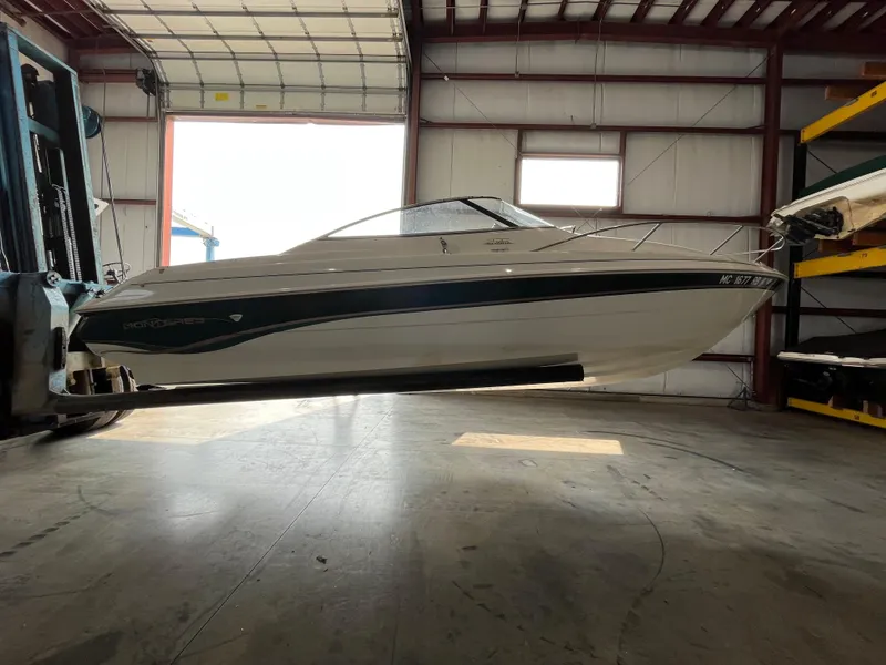 Slide: The Image of 1997 Monterey 236 Montura boat in a warehouse. - 6