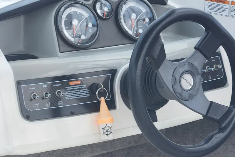 Slide: The Image of Dashboard of a 2018 Bayliner 185 Bowrider boat with steering wheel and gauges. - 10