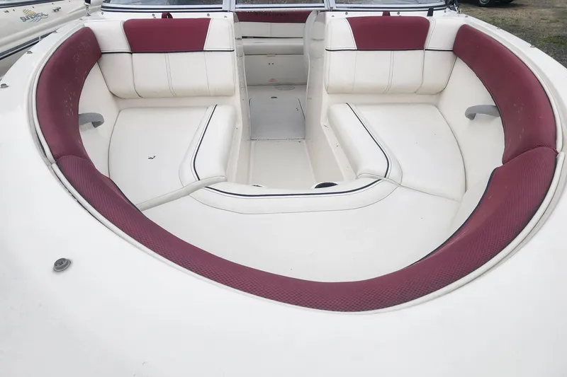 Slide: The Image of 2018 Bayliner 185 Bowrider boat interior with white and red seating. - 16