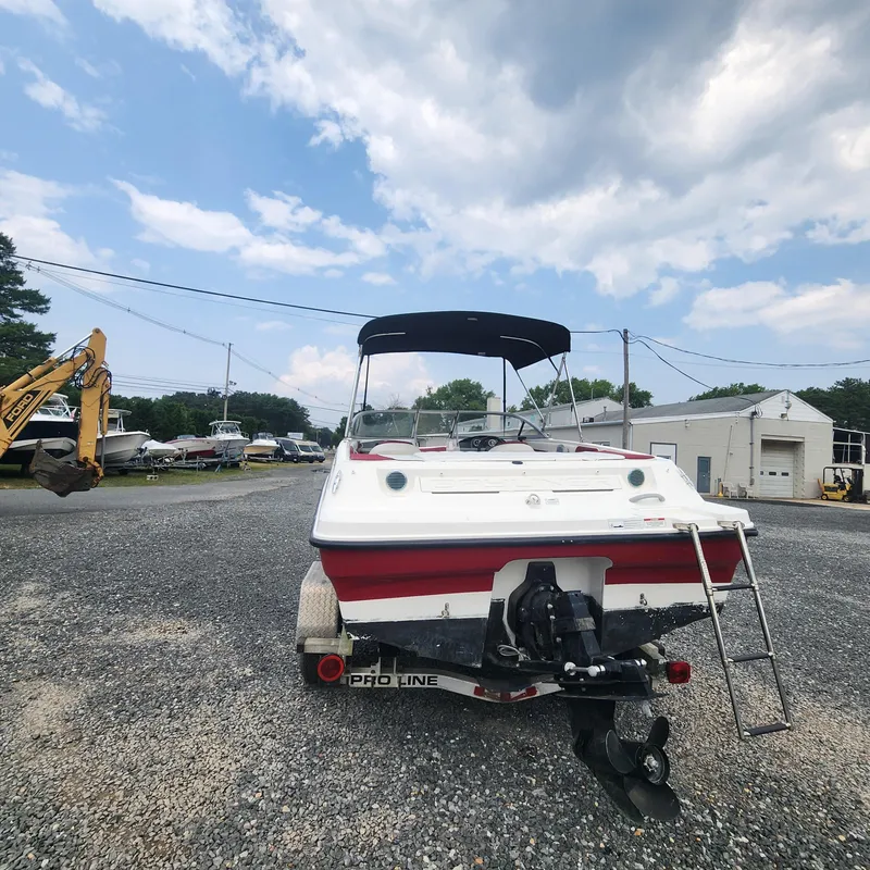 Slide: The Image of 2018 Bayliner 185 Bowrider boat on a Pro-Line trailer in a boatyard. - 2